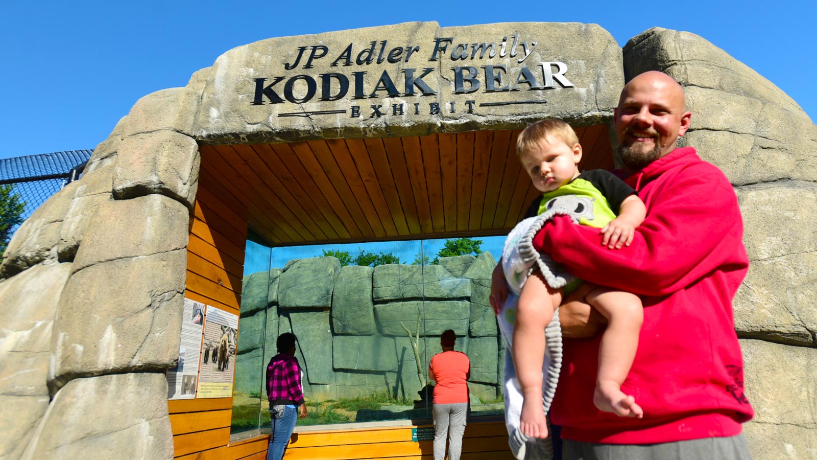 Summer attractions you shouldn’t miss: Family at Kodiak bear exhibit at Wildwood Park & Zoo Marshfield WI