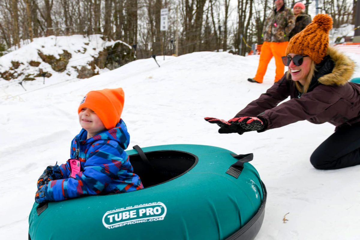 Your guide to winter fun in Marshfield | Mother and child tubing at Powers Bluff County Park in central Wisconsin