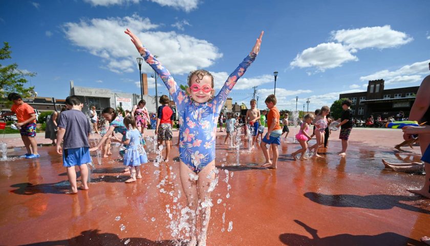 Meet Marshfield Made New: Wenzel Family Plaza | Children playing in splash pad at Wenzel Family Plaza downtown Marshfield Wisconsin