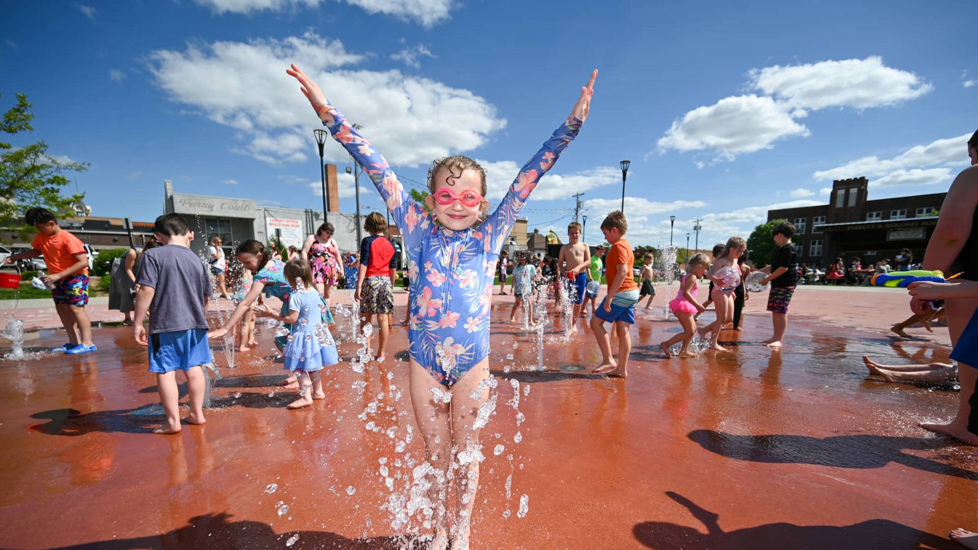 Meet Marshfield Made New: Wenzel Family Plaza | Children playing in splash pad at Wenzel Family Plaza downtown Marshfield Wisconsin