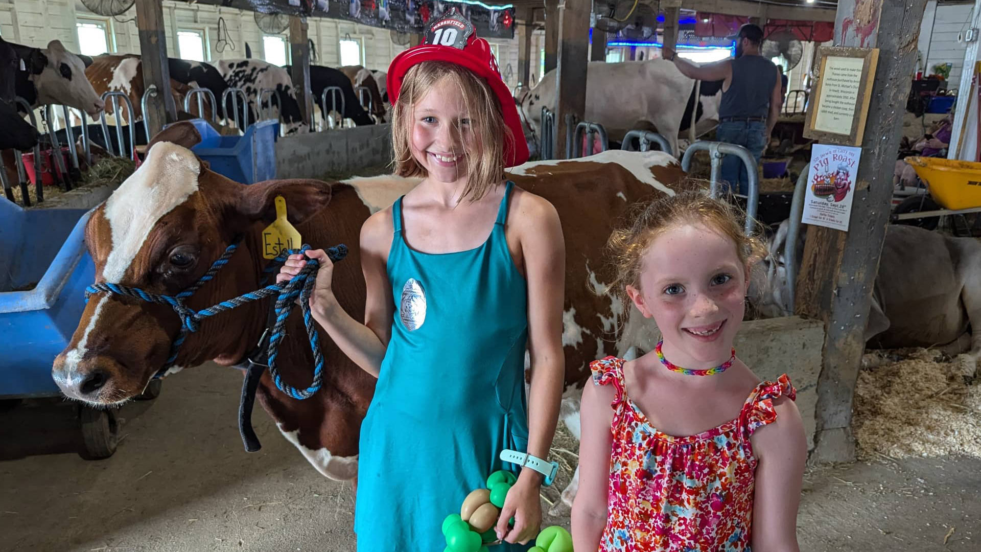 Check out some of central Wisconsin’s best festivals & summer events | Two girls posing with a cow at the Central Wisconsin State Fair in Marshfield