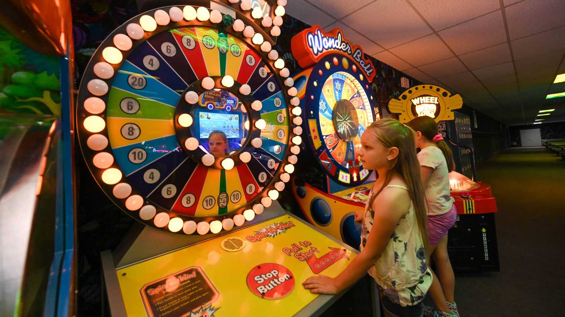 These indoor attractions in Marshfield offer fun in any weather | Two girls playing games in the arcade at Melody Gardens Restaurant & Skateland in Marshfield Wisconsin