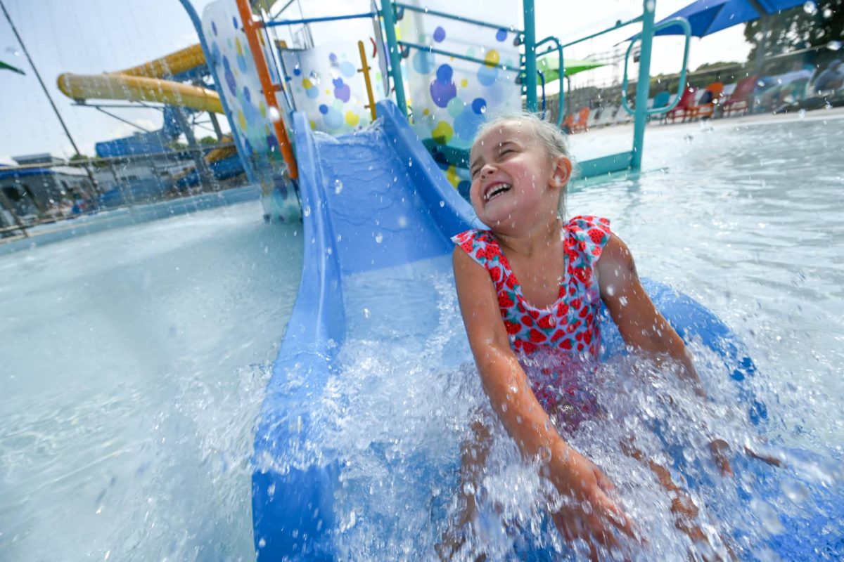 Girl going down waterslide at Vandehey Waters Aquatic Center in downtown Marshfield Wisconsin