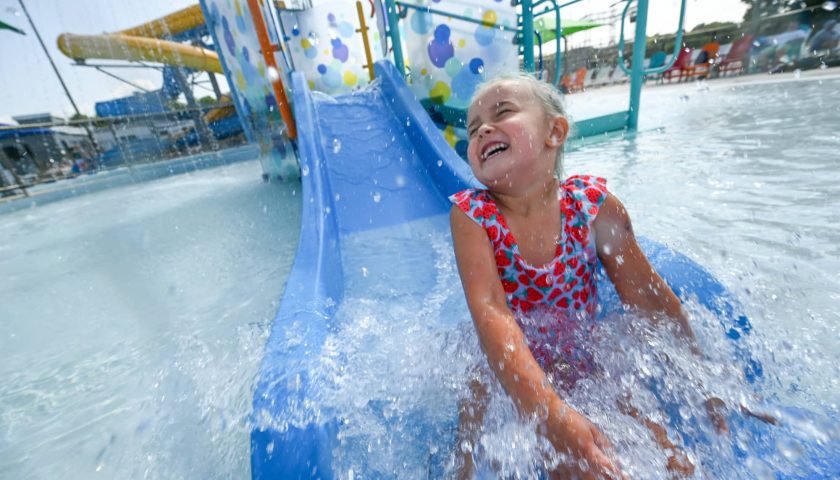Girl going down waterslide at Vandehey Waters Aquatic Center in downtown Marshfield Wisconsin