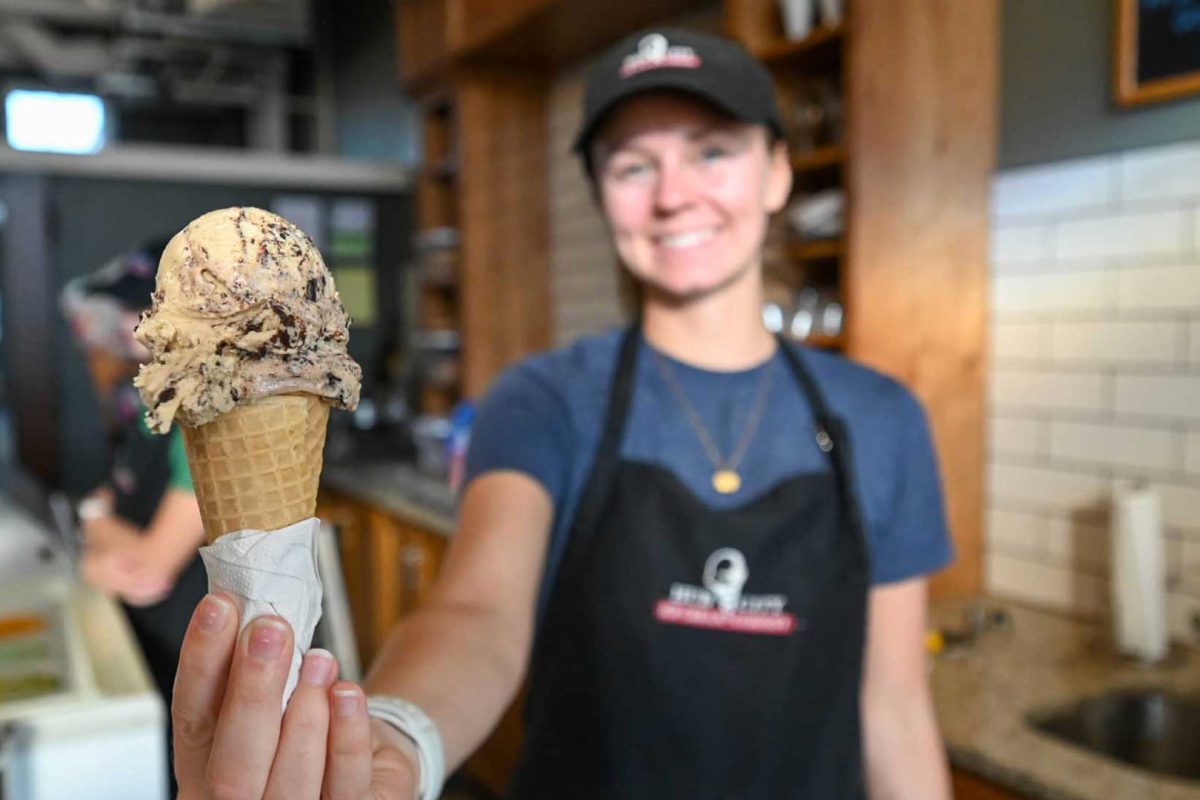 Where to find Marshfield’s best ice cream | Employee holding ice cream cone up to camera at Hub City Ice Cream in Marshfield Wisconsin