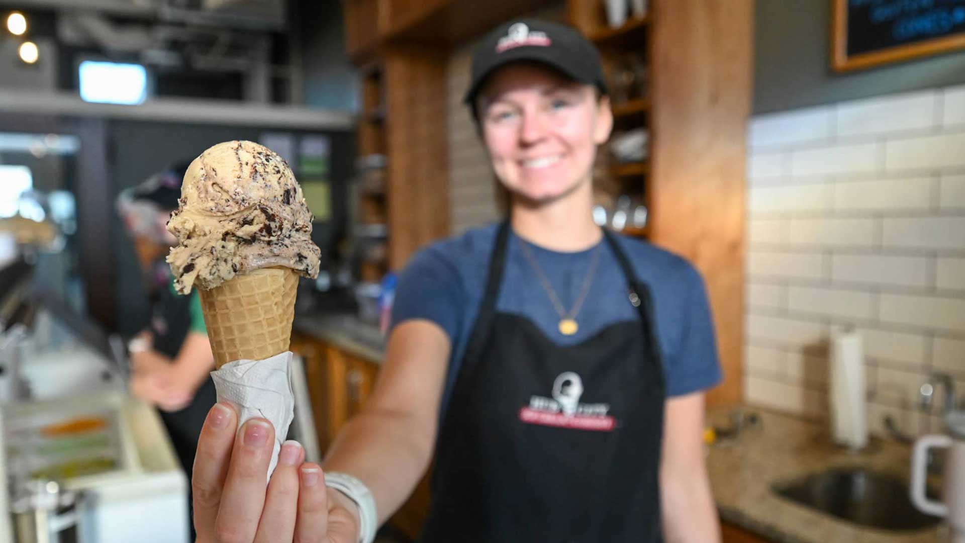 Where to find Marshfield’s best ice cream | Employee holding ice cream cone up to camera at Hub City Ice Cream in Marshfield Wisconsin